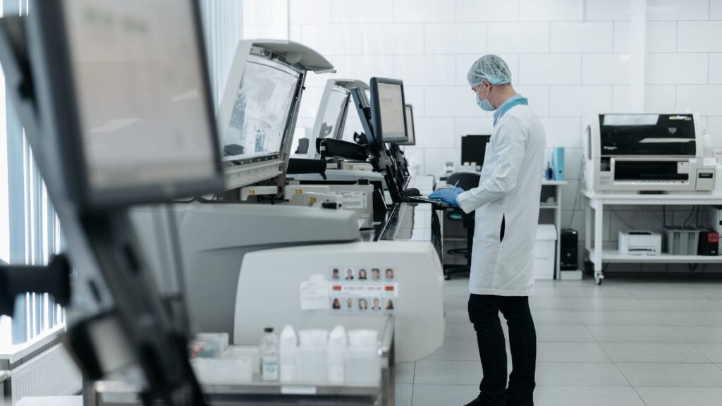 A laboratory technician operating analytical machinery.